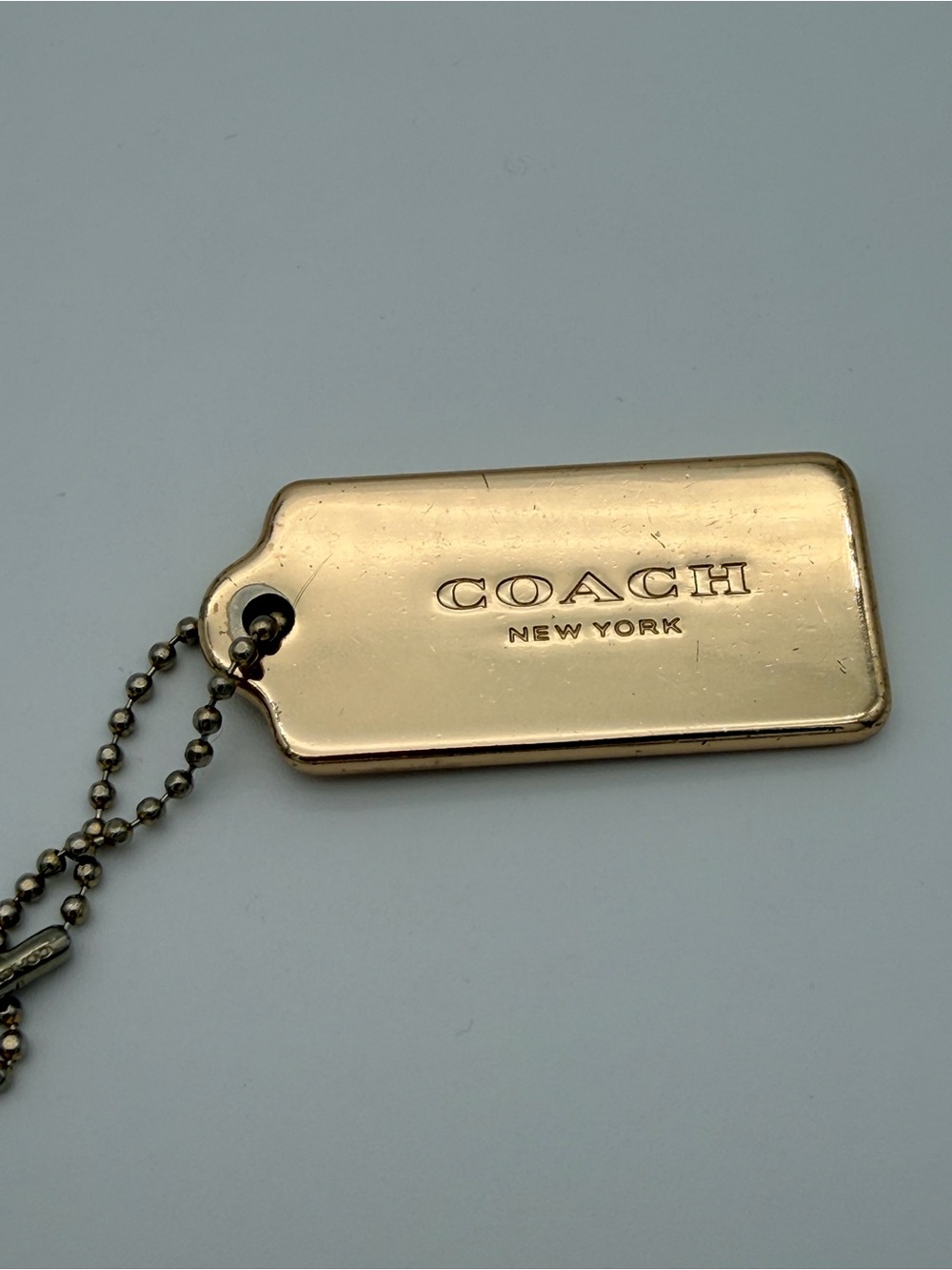 COACH New York Gold Charm Hangtag